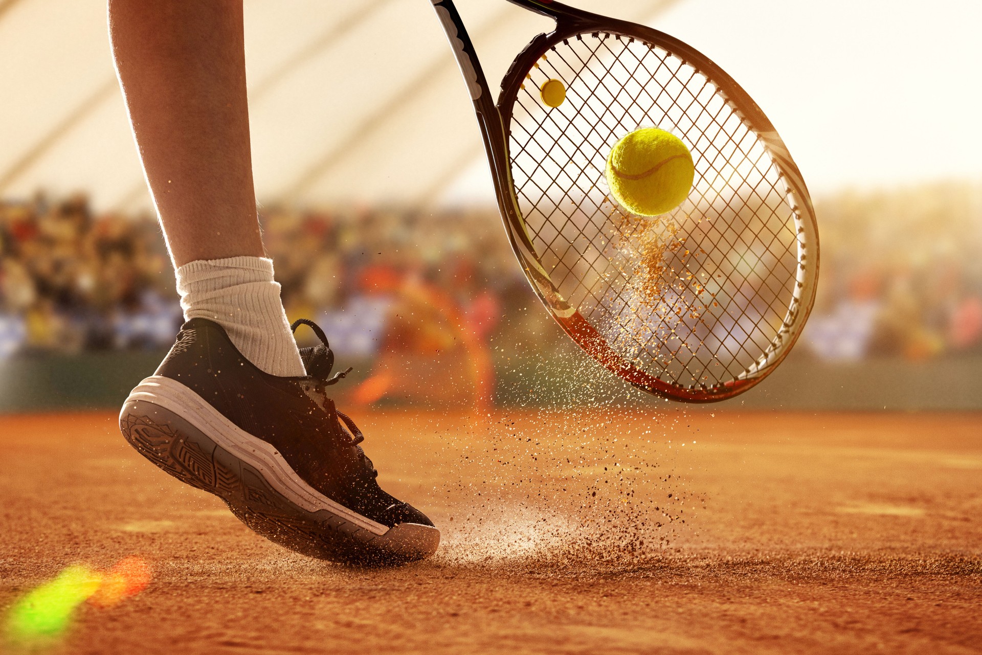 Tennis player making contact with ball on 3D clay court during match, close-up action view